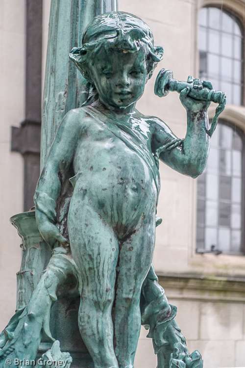 Cherub holding a telephone celebrating the fact that 2 Temple Place was one connected!