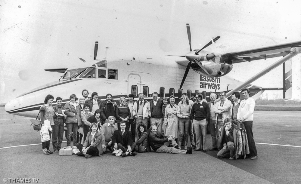 Crew in front of Eastern Airways plane.  Andy Fraser thinks the program was a drama set in France, but can’t remember name. From left back:  ?, Mandy Harper (Costume), Isobel Neil (PA), ?, Julian Meers, Floor Mgr, Director?, Bill Palmer (designer), Shirley Cleghorn Stage Mgr, Dave Copus (Props), Dave Wiles, (Props Buyer), Reg Stitch (Props), ?, ?, Jackie? (Costume), ?, Ivan Ager, Tony Taylor, Alan McGee (rigger), Alan MacMillan (Sparks), Sitting from left:  Alan Benz? (sparks), Ken Tester-Brown (lighting director) ?, Makeup?, Mike Hobbs, far right Aiden Boulter, Floor Assistant
